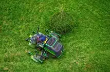 green and black ride on lawn mower on green grass field during daytime